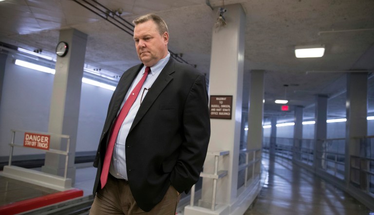 Sen. Jon Tester, D-Mont., heads to the chamber for a vote on Capitol Hill in Washington. 