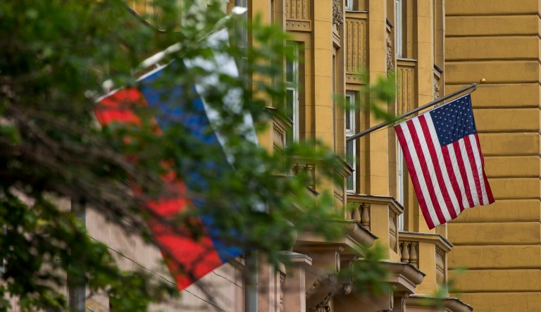 U.S. and Russian flags are seen on a building.