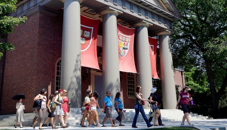 A tour group walks through the campus of Harvard University in Cambridge, Mass. A Justice Department inquiry into how race factors into admissions at Harvard University has left top-tier colleges bracing for scrutiny of practices that have boosted diversity levels to new highs. 