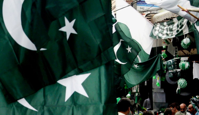 People buy flags to celebrate Pakistan's independence day in Lahore, Pakistan.