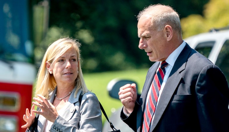 White House chief of staff John Kelly (pictured right) and Homeland Security Secretary Kirstjen Nielsen (pictured left) talk to each other at the White House in Washington, D.C.