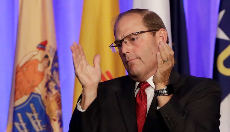 Fraternal Order of Police National President Chuck Canterbury applauds during an event.