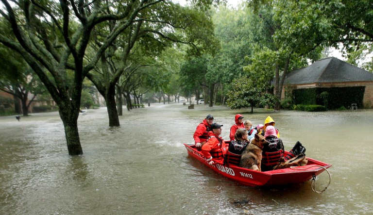 A Coast Guard rescue team evacuates people from a neighborhood inundated by floodwaters from Tropical Storm Harvey in Houston, Texas. 