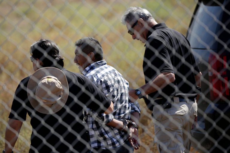 A man is detained by Border Patrol officials after breaching border fencing separating San Diego from Tijuana, Mexico, Tuesday, Sept. 26, 2017, in San Diego. The man, who said he was from Chiapas, Mexico, was detained by agents as they prepared for a news conference to announce that contractors have begun building eight prototypes of President Donald Trump's proposed border wall with Mexico.