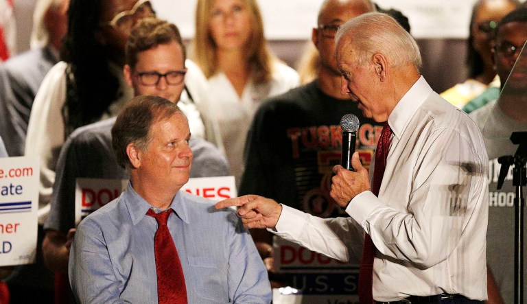 Former Vice President Joe Biden, right, speaks at a rally to campaign for Democrat Doug Jones, left, in Birmingham, Ala. 