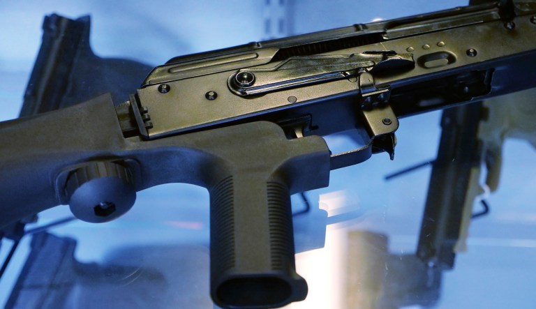 A little-known device called a bump stock is attached to a semi-automatic rifle at a gun store and shooting range. Massachusetts is on its way to becoming the first state since the Las Vegas shooting massacre to outlaw devices that allow semi-automatic weapons to mimic fully automatic guns.
