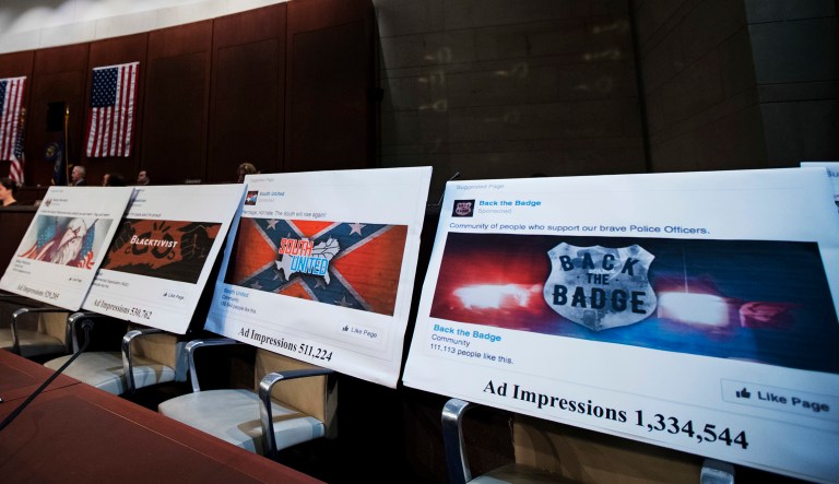 Facebook ads linked to a Russian effort to disrupt the American political process are displayed as Google's Senior Vice President and General Counsel Kent Walker, Facebook's General Counsel Colin Stretch, and Twitter's Acting General Counsel Sean Edgett, testify during a House Intelligence Committee hearing on Capitol Hill in Washington, Wednesday, Nov. 1, 2017.