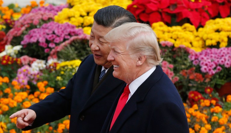 U.S. President Donald Trump, right, chats with Chinese President Xi Jinping during a welcome ceremony at the Great Hall of the People in Beijing, Thursday, Nov. 9, 2017.