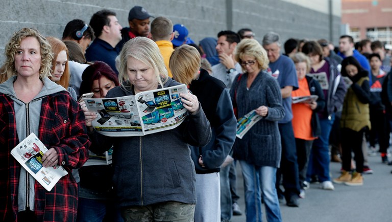 People wait in line for a Best Buy store to open for a Black Friday sale on Thanksgiving Day.