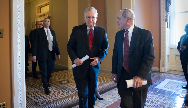 Senate Majority Leader Mitch McConnell, R-Ky., confers with Sen. Jim Risch, R-Idaho, right, chairman of the Senate Small Business Committee, as they walk to a news conference to talk about the Republican tax plan and how they say it will help small business, on Capitol Hill in Washington, Tuesday, Nov. 28, 2017. 