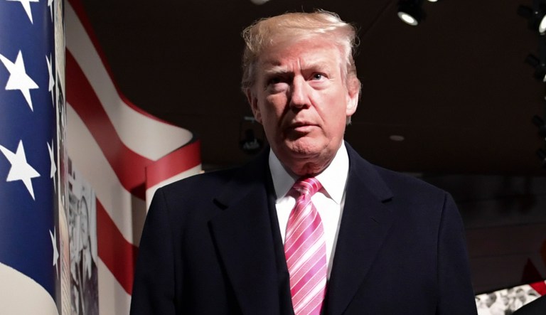President Donald Trump, left, gets a tour of the newly-opened Mississippi Civil Rights Museum in Jackson, Miss., Saturday, Dec. 9, 2017. Mississippi Gov. Phil Bryant, watches at right.