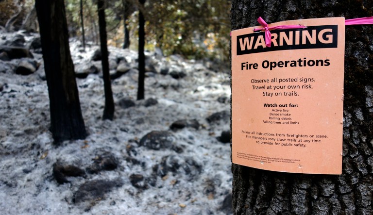 This Oct. 30, 2017 photo shows a notice warning visitors of controlled-fire operations in Kings Canyon National Park, Calif.  Californiaâs seemingly endless cycle of wildfires is helping drive plans to do more âcontrolled burnsâ that thin forests choked with dead trees and withered underbrush that if left unchecked can feed monster blazes that force entire communities to flee, destroy homes and take lives. The goal for 2018 is to burn at least 20,000 acres and to clear another 20,000 by crews using chain saws, bulldozers and other machinery.