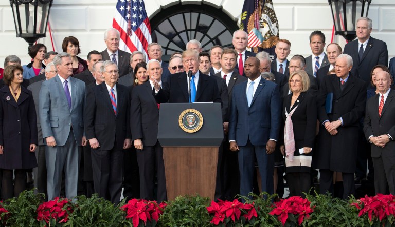 President Trump joined by Senate Majority Leader Mitch McConnell of Ky., Vice President Mike Pence, Speaker of the House Paul Ryan, R-Wis., and other members of congress speaks during an event on the South Lawn of the White House to acknowledge the final passage of tax overhaul legislation by congress.