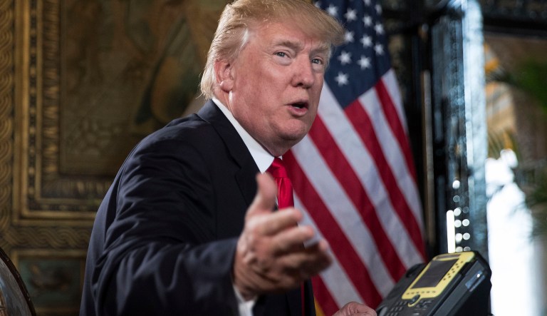 President Donald Trump turns to talk to the gathered media during a Christmas Eve video teleconference with members of the mIlitary at his Mar-a-Lago estate in Palm Beach, Fla., Sunday, Dec. 24, 2017.