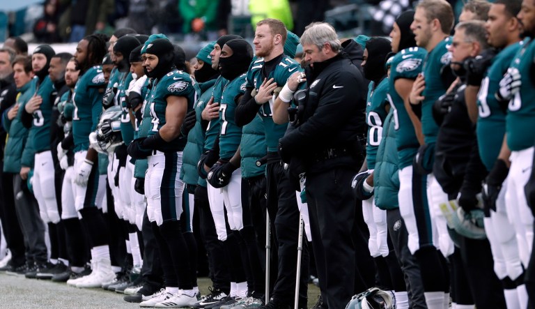 Philadelphia Eagles listens to the national anthem before an NFL football game. 
