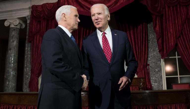 Vice President Mike Pence, left, shakes hands with former Vice President Joe Biden at the Capitol in Washington, Wednesday, Jan. 3, 2018.  