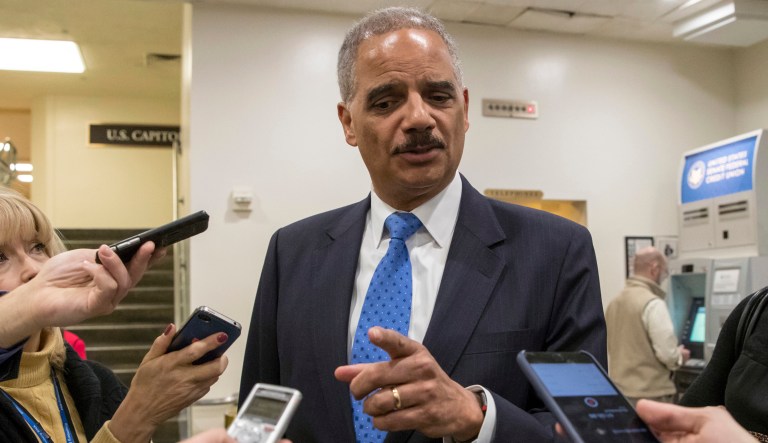 Former Attorney General Eric Holder takes questions from reporters at the Capitol on Wednesday, Jan. 3, 2018.