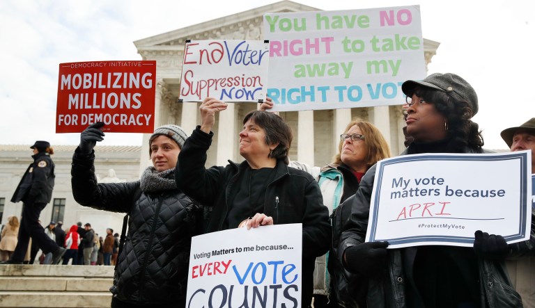 People rally outside of the Supreme Court in opposition to Ohio's voter roll purges in Washington. 