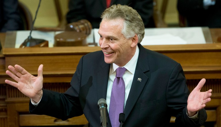 Virginia Gov. Terry McAuliffe gestures as he arrives to address a joint session of the the 2018 session in the House chambers at the Capitol in Richmond, Va., Wednesday, Jan. 10, 2018.