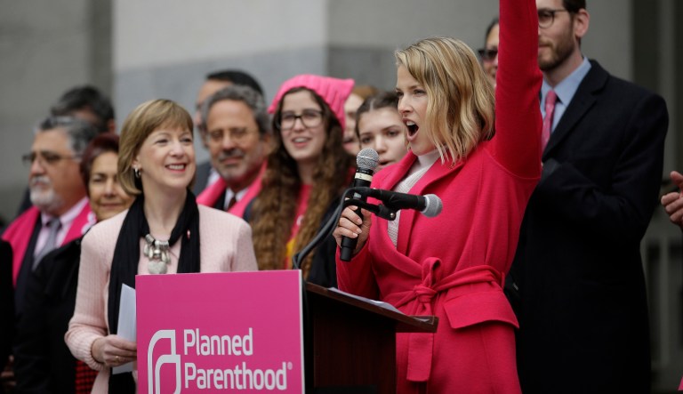 Actor Ali Larter raises her fist while speaking at a rally held by Planned Parenthood,  commemorating the 45th anniversary of Roe v. Wade at the Capitol Monday, Jan. 22, 2018, in Sacramento, Calif.