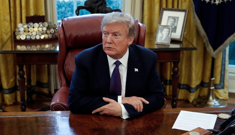 President Trump sits at the Resolute Desk. 