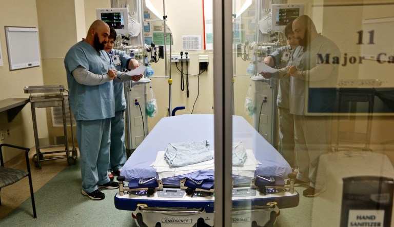 A doctor and nurse confer inside a room used for flu patients at Northside Hospital near Atlanta, Ga.