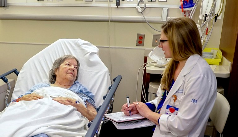 Emily Ruben, right, talks withÂ Northwestern Memorial Hospital patient Carol Wittwer at her bedside in a special wing of the Emergency Department in Chicago on Jan. 10, 2018.