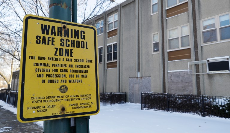 In this Jan. 18, 2018, photo, a safe school zone sign still hangs at the closed Arna Wendell Bontemps Elementary School in the Englewood neighborhood of Chicago. Five years after the nation's largest mass closure of public schools, Chicago is forging ahead with plans to shutter four more in one of the city's highest-crime and impoverished areas while school officials are pitching the new closures in Englewood to make way for a new $85 million school they insist will better serve students and reverse low enrollment.
