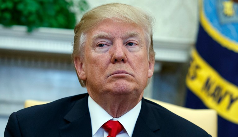 President Trump listens during a meeting in the Oval Office of the White House, Friday, Feb. 2, 2018, in Washington.