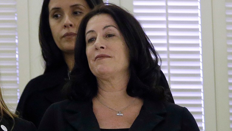 Dressed in black, Lobbyist Samantha Corbin, third from left, links arms with activist Christine Pelosi, fourth from left, the daughter of House Minority Leader, Nancy Pelosi, in the Assembly gallery as lawmakers discuss a measure to give whistleblower protection for legislative staff members, Monday, Feb. 5, 2018, in Sacramento, Calif. The bill, AB403, by Assemblywoman Melissa Melendez, R-Lake Elsinore, was approved by the Assembly and now goes to Gov. Jerry Brown. (AP Photo/Rich Pedroncelli)