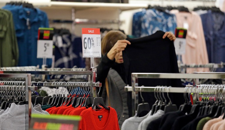 A shopper looks over clothing. The Labor Department reports on U.S. consumer prices. 