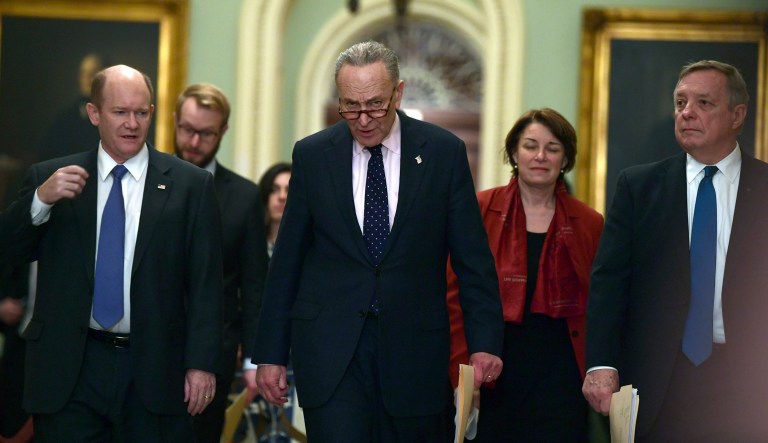Senate Minority Leader Sen. Chuck Schumer of N.Y., walks with Sen. Chris Coons, D-Del., Sen. Amy Klobuchar, D-Minn., and Sen. Dick Durbin, D-Ill., as they walks to speak to reporters on Capitol Hill. 