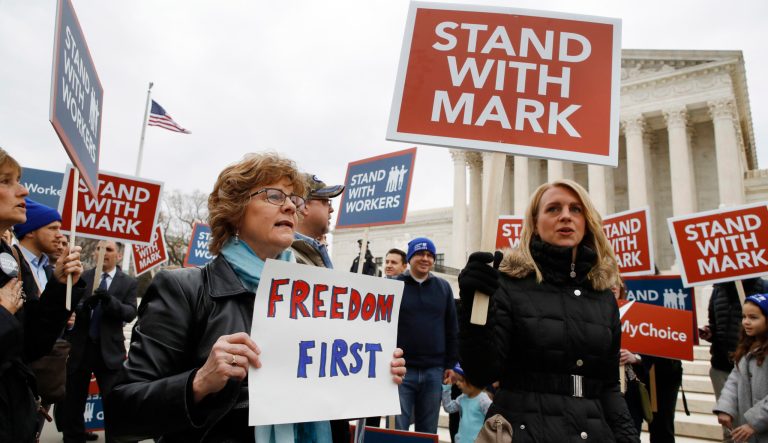 Cindy Omlin, left, of Spokane, Washington, and Lindsay Killen, right, of Midland, Mich., rally with others in opposition to union fees, outside of the Supreme Court, Monday, Feb. 26, 2018, in Washington.