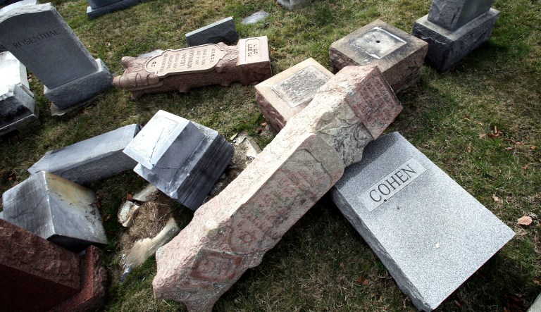 In this Feb. 27, 2017 file photo, headstones toppled and damaged by vandals lie on the ground at Mount Carmel Cemetery in Philadelphia.
