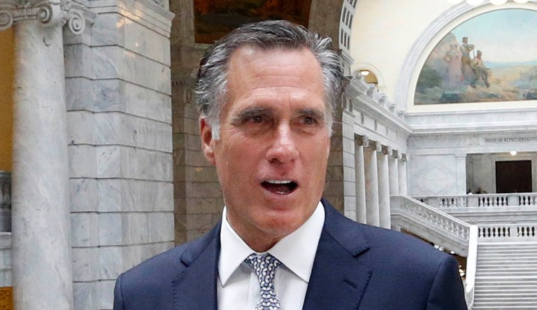 Mitt Romney speaks to reporters.