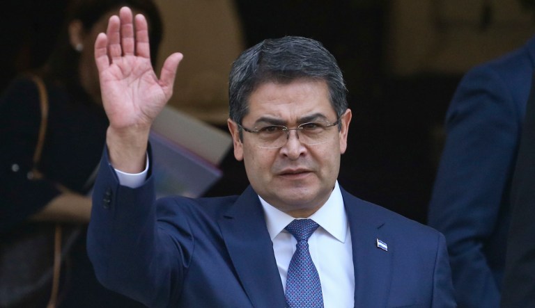  Juan Orlando Hernandez, the president of Honduras, waves to people after an event.