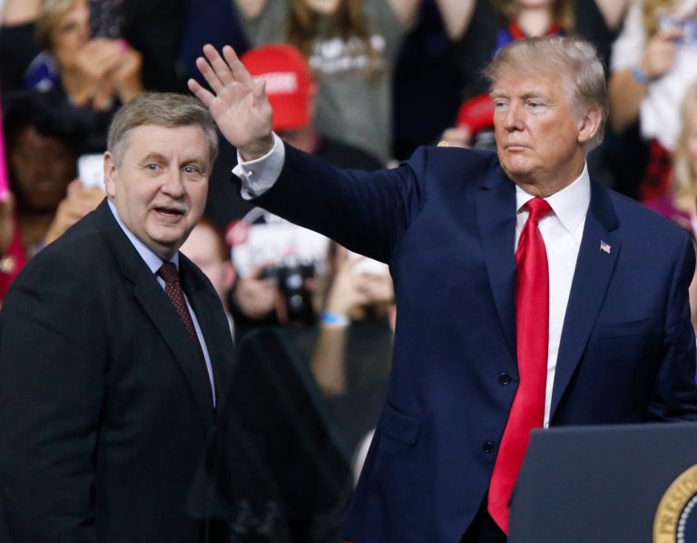 President Donald Trump, right, acknowledges the crowd during a campaign rally with Republican Rick Saccone in Moon Township, Pa.