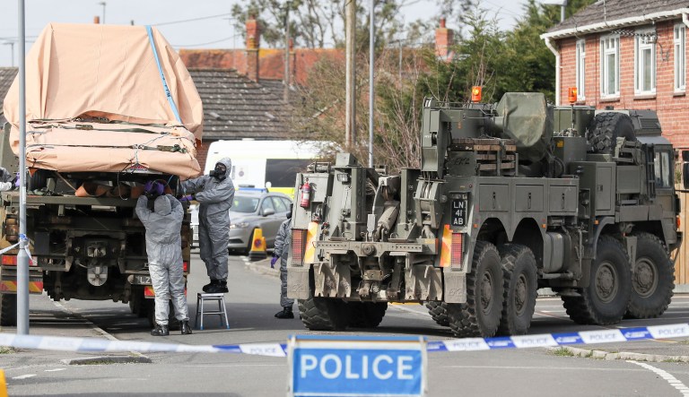 Soldiers wearing protective clothing  lift a tow truck in Dorset, England, as the investigation into the suspected nerve agent attack on Russian double agent Sergei Skripal continues.