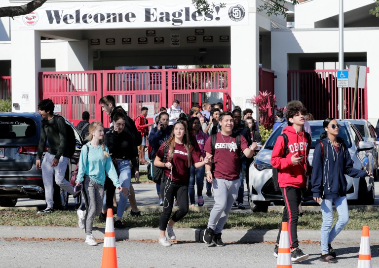 Students walk out of Marjory Stoneman Douglas High School as part of a nationwide protest against gun violence on Wednesday in Parkland, Fla. Organizers say nearly 3,000 walkouts are set in the biggest demonstration yet of the student activism that has emerged following the massacre of 17 people at Marjory Stoneman Douglas High School in February.