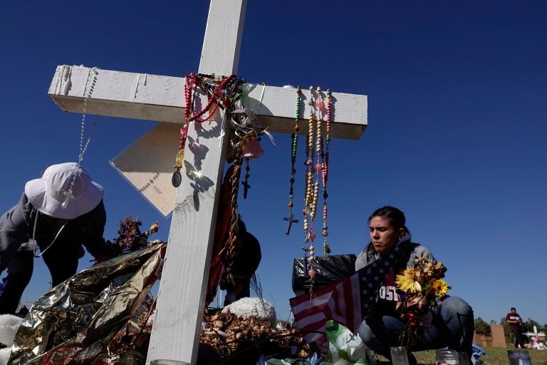 Volunteers Annabelle Andon, left, and Joanna Polk, remove items left at the memorials for the Marjory Stoneman Douglas High School shooting victims, Thursday, March 15, 2018, at Pine Trails Park in Parkland, Fla.  