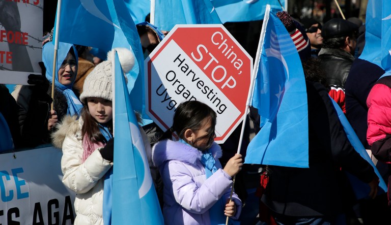 Uighurs and their supporters rally across the street from United Nations headquarters in New York, Thursday, March 15, 2018.