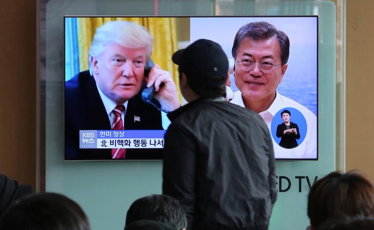 A man watches a TV screen showing South Korean President Moon Jae-in, right, and U.S. President Donald Trump during a news program at the Seoul Railway Station in Seoul, South Korea, Saturday, March 17, 2018. Trump and Moon, who are both planning to meet North Korea's leader Kim Jong Un this spring, pledged Friday to maintain "maximum pressure" on his authoritarian regime and seek action on giving up his nukes, the White House said.