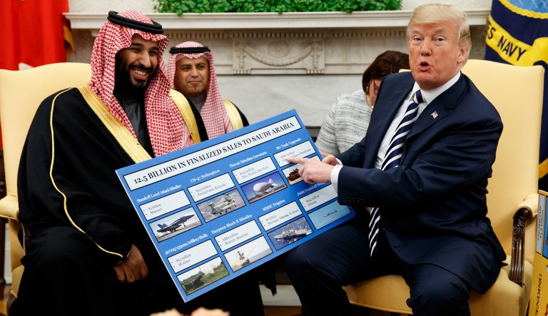 President Donald Trump shows a chart highlighting arms sales to Saudi Arabia during a meeting with Saudi Crown Prince Mohammed bin Salman in the Oval Office of the White House, Tuesday, March 20, 2018, in Washington.
