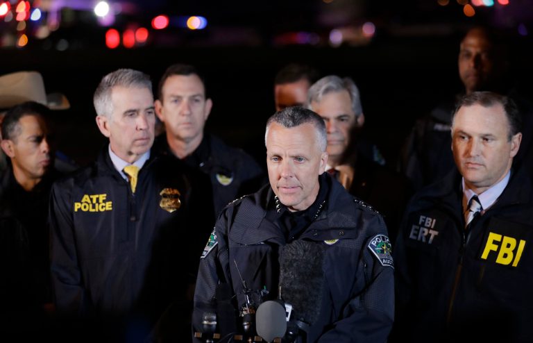 Austin Police Chief Brian Manley, center, stands with other members of law enforcement as he briefs the media, Wednesday, March 21, 2018, in the Austin suburb of Round Rock, Texas. The suspect in a spate of bombing attacks that have terrorized Austin over the past month blew himself up with an explosive device as authorities closed in, the police said early Wednesday.