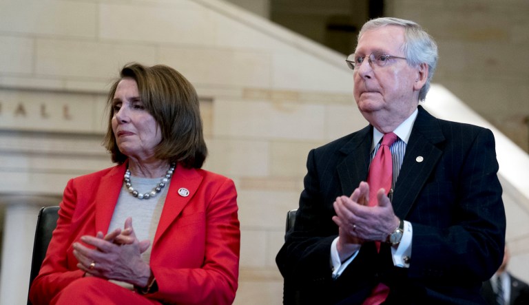 House Minority Leader Nancy Pelosi of California and Senate Majority Leader Mitch McConnell of Kentucky appear for a Congressional Gold Medal Ceremony honoring the Office of Strategic Services in Emancipation Hall on Capitol Hill in Washington, Wednesday, March 21, 2018.