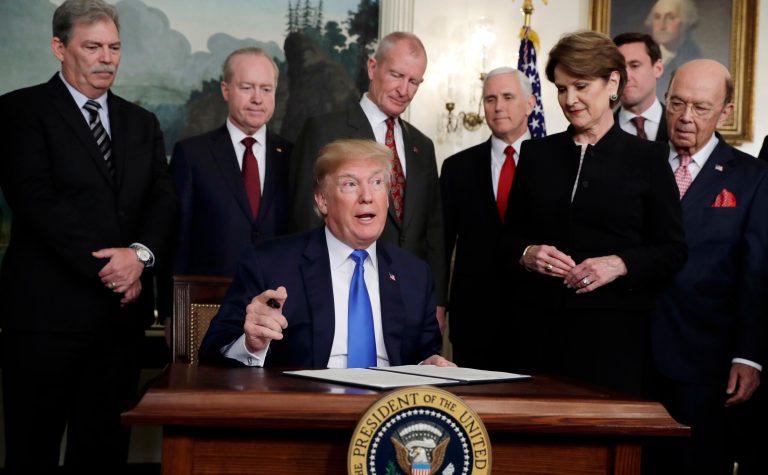 President Trump signs a presidential memorandum imposing tariffs and investment restrictions on China in the Diplomatic Reception Room of the White House on Thursday in Washington.