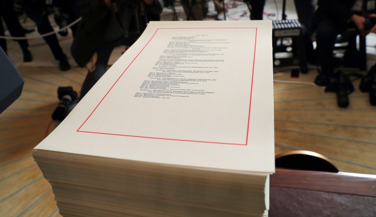 A copy of the $1.3 trillion spending bill is stacked on a table in the Diplomatic Room of the White House in Washington on March 23, 2018.