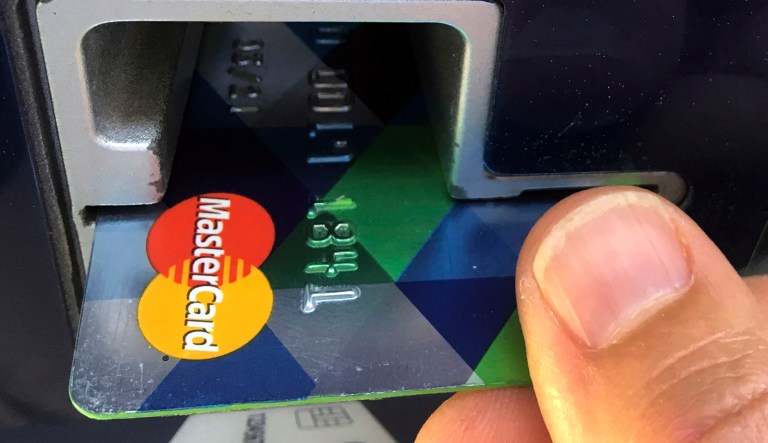 A customer inserts a credit card to pay for something.