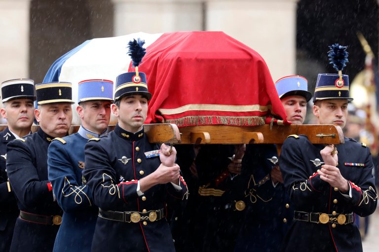 French Republican Guards and cadets from the joint-army military school (Ecole Militaire Interarmes, EMIA) carry the coffin of late Lt. Col. Arnaud Beltrame during a national ceremony for Beltrame on Wednesday at the Hotel des Invalides in Paris. The slain hero of last week's extremist attack in southern France is being honored in an elaborate, daylong national homage led by French President Emmanuel Macron.