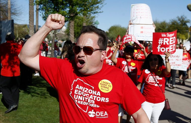 Arizona teachers and education advocates shout as they march at the Arizona Capitol highlighting low teacher pay and school funding Wednesday, March 28, 2018, in Phoenix.